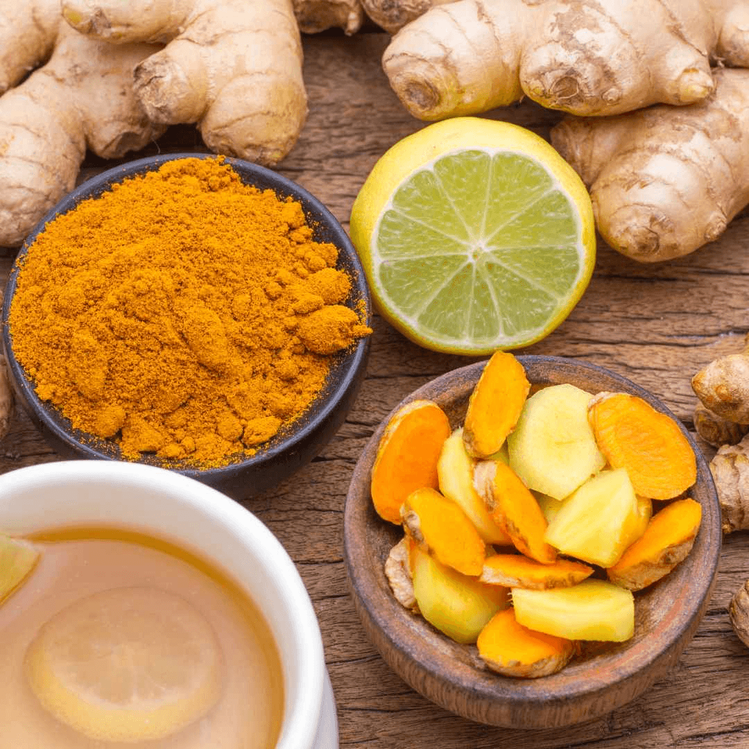 Garlic, lemon, ginger, and turmeric arranged on a cutting board